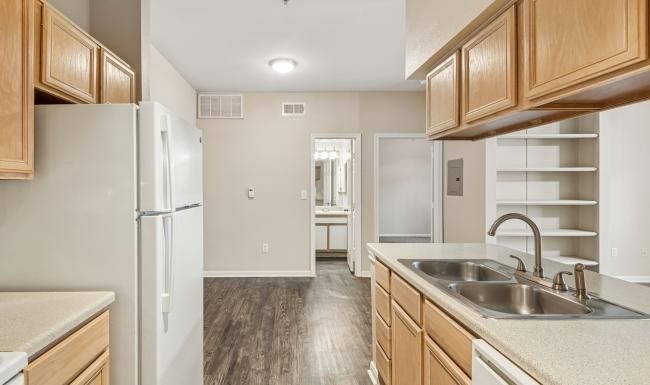a kitchen with wooden cabinets