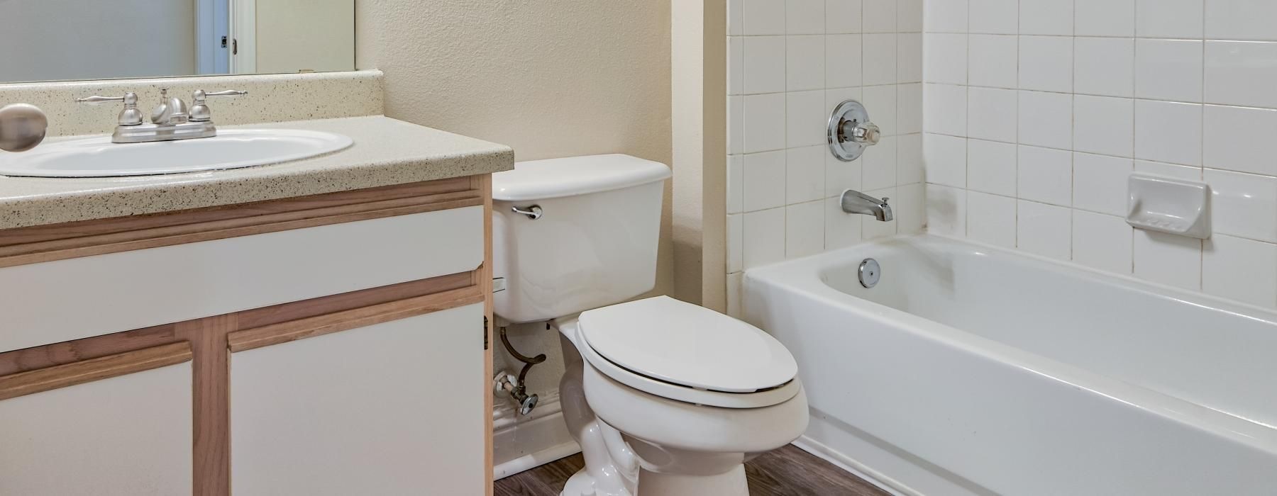 a bathroom with a tub, toilet and sink