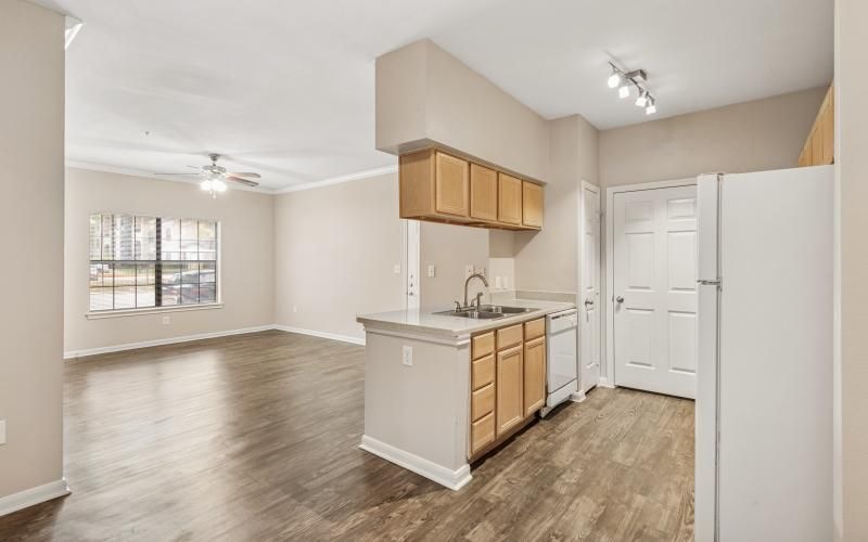 an empty kitchen and living room with a window